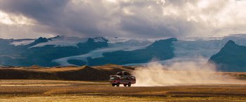 Movie still from “The Secret Life of Walter Mitty” (2013), directed by Ben Stiller – A truck driving down a dirt road near a mountain range; Extreme Wide shot, Low angle