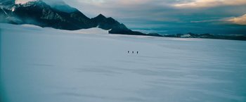 Movie still from “The Secret Life of Walter Mitty” (2013), directed by Ben Stiller – A group of people walking across a snow covered field; Extreme Wide shot, High angle