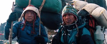 Movie still from “The Secret Life of Walter Mitty” (2013), directed by Ben Stiller – A couple of people that are standing in the dirt; Medium shot, Low angle