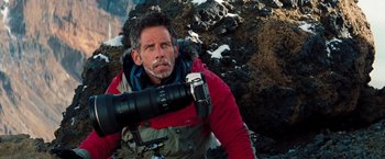 Movie still from “The Secret Life of Walter Mitty” (2013), directed by Ben Stiller – A man in a red jacket holding a camera in his hand; Close Up shot, Low angle