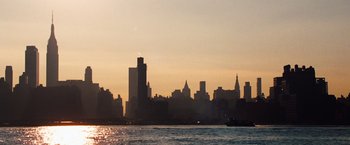 Movie still from “The Secret Life of Walter Mitty” (2013), directed by Ben Stiller – The sun is setting over a large city; Extreme Wide shot, Low angle
