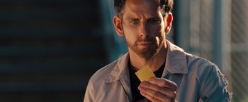 Movie still from “The Secret Life of Walter Mitty” (2013), directed by Ben Stiller – A person holding a piece of paper; Close Up shot, Over the shoulder angle