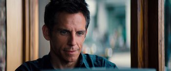 Movie still from “The Secret Life of Walter Mitty” (2013), directed by Ben Stiller – A person with a beard looking at the camera; Close Up shot, Over the shoulder angle