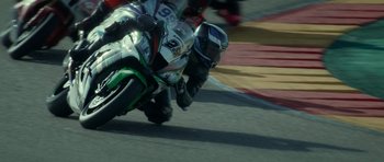 Movie still from “Centaur” (2022), directed by Daniel Calparsoro – A person on a motorcycle on a race track; Wide shot, High angle