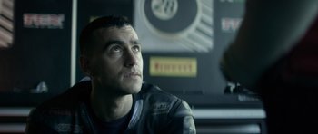 Movie still from “Centaur” (2022), directed by Daniel Calparsoro – A person sitting in a car; Close Up shot, Low angle