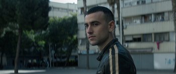 Movie still from “Centaur” (2022), directed by Daniel Calparsoro – A person wearing a leather jacket; Close Up shot, Low angle