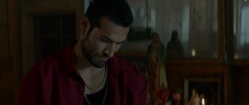 Movie still from “Centaur” (2022), directed by Daniel Calparsoro – A person wearing a red shirt; Close Up shot, Over the shoulder angle