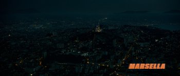Movie still from “Centaur” (2022), directed by Daniel Calparsoro – An aerial view of a city at night with lights on; Extreme Wide shot, High angle