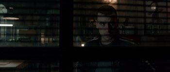 Movie still from “Centaur” (2022), directed by Daniel Calparsoro – A man looking out of a window at night; Close Up shot, Over the shoulder angle