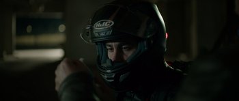 Movie still from “Centaur” (2022), directed by Daniel Calparsoro – A man wearing a motorcycle helmet in the dark; Close Up shot, Low angle