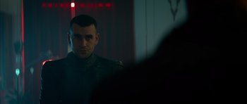 Movie still from “Centaur” (2022), directed by Daniel Calparsoro – A man is looking at the reflection of himself in a mirror; Close Up shot, Over the shoulder angle