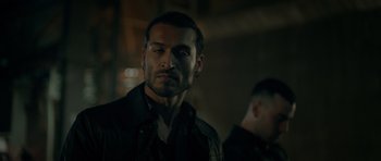 Movie still from “Centaur” (2022), directed by Daniel Calparsoro – A person wearing a jacket; Close Up shot, Over the shoulder angle