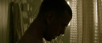 Movie still from “Centaur” (2022), directed by Daniel Calparsoro – A man in the shower taking a shower with water; Close Up shot, Low angle