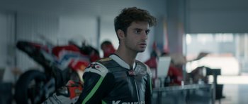 Movie still from “Centaur” (2022), directed by Daniel Calparsoro – A person wearing a motorcycle jacket; Close Up shot, Over the shoulder angle