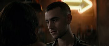 Movie still from “Centaur” (2022), directed by Daniel Calparsoro – A person wearing a shirt; Close Up shot, Over the shoulder angle