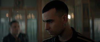 Movie still from “Centaur” (2022), directed by Daniel Calparsoro – A person with short hair; Close Up shot, Over the shoulder angle