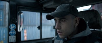 Movie still from “Centaur” (2022), directed by Daniel Calparsoro – A person wearing a hat; Close Up shot, Low angle