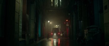 Movie still from “Centaur” (2022), directed by Daniel Calparsoro – A car driving down a street at night; Extreme Wide shot, Low angle