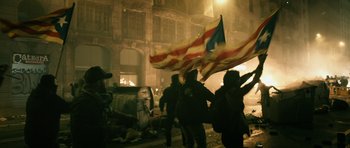 Movie still from “Centaur” (2022), directed by Daniel Calparsoro – A group of people standing next to each other holding flags; Extreme Wide shot, Low angle