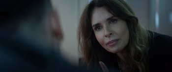 Movie still from “Centaur” (2022), directed by Daniel Calparsoro – A woman's face as she looks at the camera; Close Up shot, Over the shoulder angle