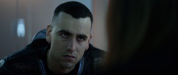 Movie still from “Centaur” (2022), directed by Daniel Calparsoro – A person wearing a black jacket; Close Up shot, Over the shoulder angle