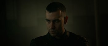 Movie still from “Centaur” (2022), directed by Daniel Calparsoro – A person wearing a black shirt; Close Up shot, Low angle