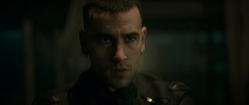 Movie still from “Centaur” (2022), directed by Daniel Calparsoro – A person wearing a black shirt; Close Up shot, Low angle