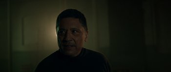 Movie still from “Centaur” (2022), directed by Daniel Calparsoro – A person in a dark room; Close Up shot, Low angle