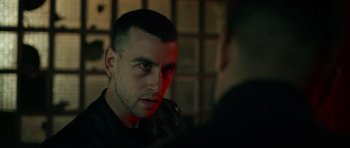 Movie still from “Centaur” (2022), directed by Daniel Calparsoro – A person in a dark room; Close Up shot, Over the shoulder angle