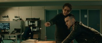 Movie still from “Centaur” (2022), directed by Daniel Calparsoro – A man sitting at a table with a woman; Medium shot, Over the shoulder angle