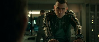 Movie still from “Centaur” (2022), directed by Daniel Calparsoro – A man in a leather jacket is looking at the camera; Close Up shot, Low angle