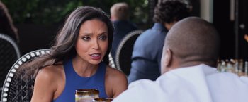 Movie still from “Central Intelligence” (2016), directed by Rawson Marshall Thurber – A woman sitting at a table with a glass of wine; Close Up shot, Over the shoulder angle