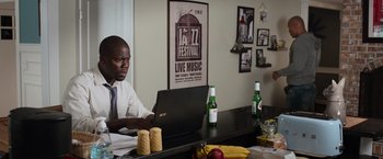 Movie still from “Central Intelligence” (2016), directed by Rawson Marshall Thurber – A man sitting in front of a laptop computer; Medium shot, Over the shoulder angle