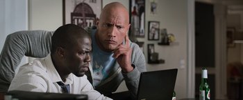 Movie still from “Central Intelligence” (2016), directed by Rawson Marshall Thurber – Two men looking at a laptop computer screen; Close Up shot, Over the shoulder angle