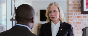 Movie still from “Central Intelligence” (2016), directed by Rawson Marshall Thurber – A woman wearing a suit and tie talking to a man in a black suit; Close Up shot, Over the shoulder angle