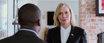Movie still from “Central Intelligence” (2016), directed by Rawson Marshall Thurber – A woman wearing a suit and tie talking to a man in a suit; Close Up shot, Over the shoulder angle