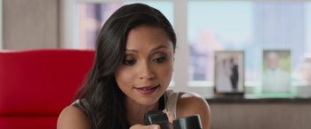 Movie still from “Central Intelligence” (2016), directed by Rawson Marshall Thurber – A beautiful young woman holding a remote control; Close Up shot, High angle