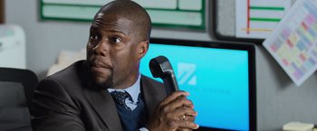 Movie still from “Central Intelligence” (2016), directed by Rawson Marshall Thurber – A person holding a phone; Close Up shot, Over the shoulder angle