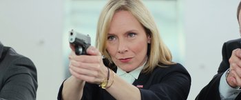 Movie still from “Central Intelligence” (2016), directed by Rawson Marshall Thurber – A woman holding a gun in her hand; Close Up shot, Low angle