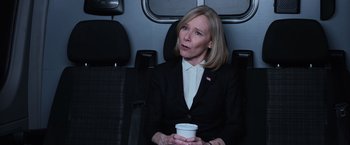 Movie still from “Central Intelligence” (2016), directed by Rawson Marshall Thurber – A woman sitting on a seat holding a drink; Medium shot, High angle