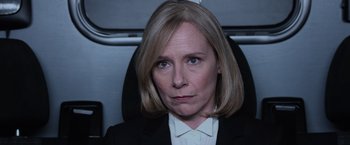 Movie still from “Central Intelligence” (2016), directed by Rawson Marshall Thurber – A woman with blonde hair wearing a black suit; Close Up shot, High angle