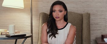 Movie still from “Central Intelligence” (2016), directed by Rawson Marshall Thurber – A woman sitting in a chair in front of a wooden wall; Close Up shot, Over the shoulder angle