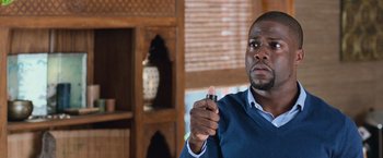 Movie still from “Central Intelligence” (2016), directed by Rawson Marshall Thurber – A man holding a pen in his right hand; Close Up shot, Over the shoulder angle
