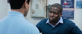 Movie still from “Central Intelligence” (2016), directed by Rawson Marshall Thurber – A man in a blue shirt is talking to another man; Close Up shot, Over the shoulder angle