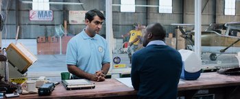 Movie still from “Central Intelligence” (2016), directed by Rawson Marshall Thurber – A man in blue shirt talking to another man in blue shirt; Medium shot, Over the shoulder angle