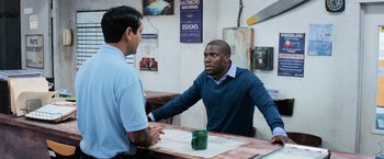 Movie still from “Central Intelligence” (2016), directed by Rawson Marshall Thurber – Two men are having a conversation at a table; Medium shot, Over the shoulder angle