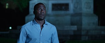 Movie still from “Central Intelligence” (2016), directed by Rawson Marshall Thurber – A man in a blue dress shirt is looking up; Close Up shot, Over the shoulder angle