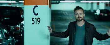 Movie still from “Central Intelligence” (2016), directed by Rawson Marshall Thurber – A man is pointing to a parking garage sign; Close Up shot, Low angle