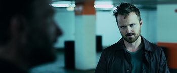 Movie still from “Central Intelligence” (2016), directed by Rawson Marshall Thurber – A man standing in a parking lot wearing a leather jacket; Close Up shot, Over the shoulder angle