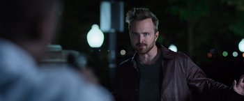 Movie still from “Central Intelligence” (2016), directed by Rawson Marshall Thurber – A man in a leather jacket standing in the dark; Close Up shot, Over the shoulder angle